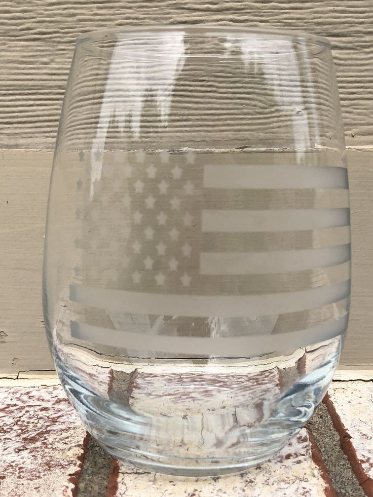 a clear glass with an american flag painted on it