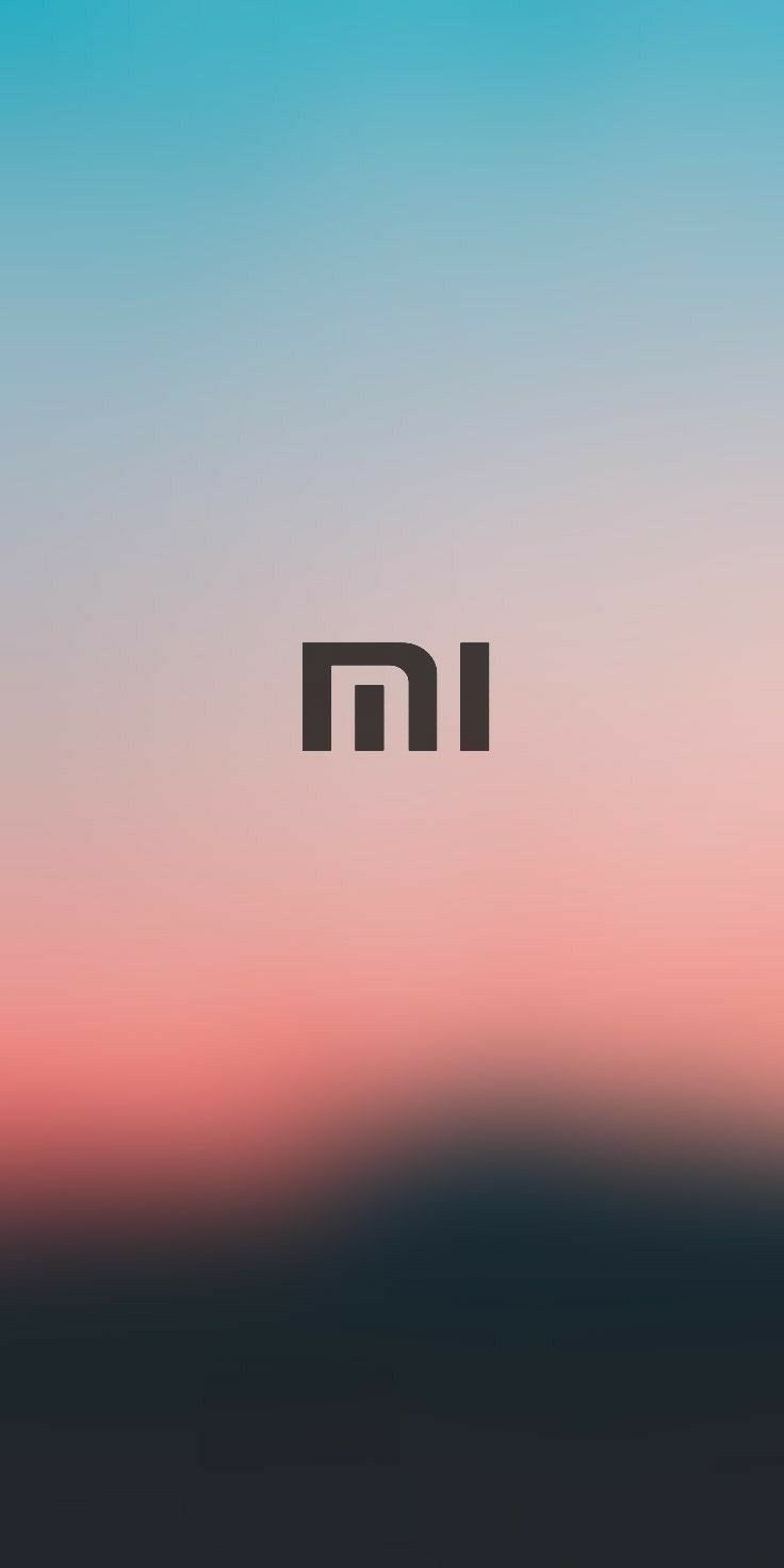 an image of the letter m in black and white on a blurry sky background