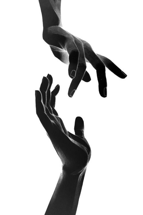 two hands reaching for each other in the air