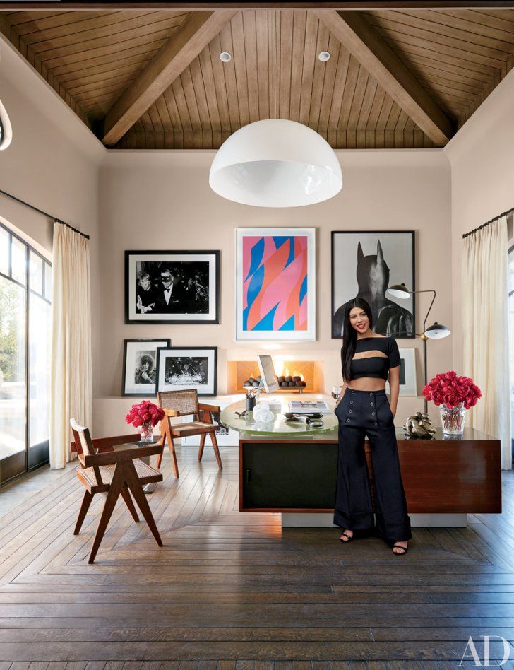 a living room filled with furniture and pictures on the wall