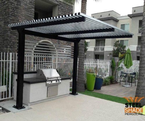 an outdoor bbq with grill and seating area