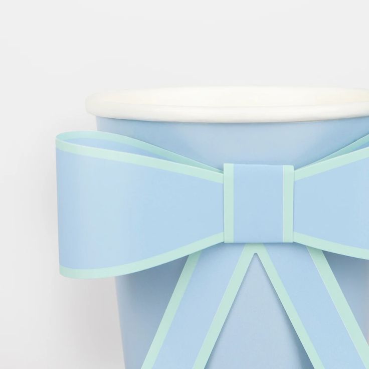 a blue cup with a bow on it