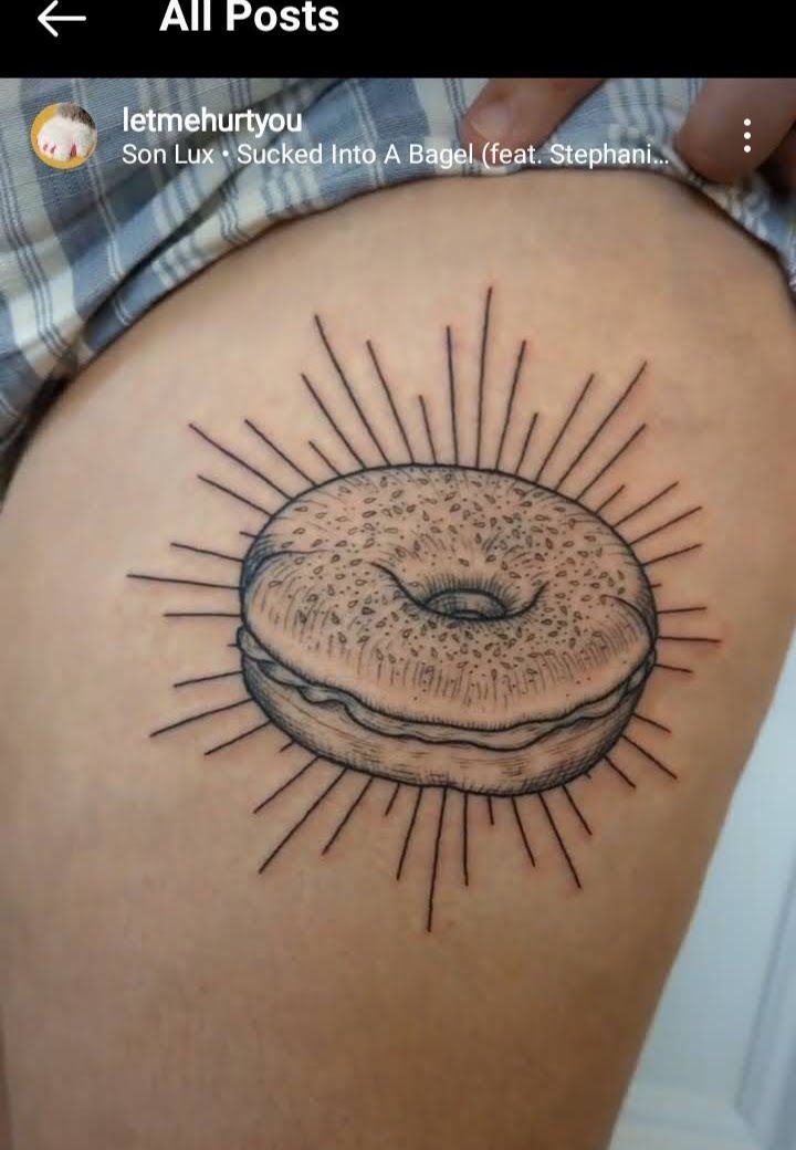 a woman's thigh with a donut tattoo on it