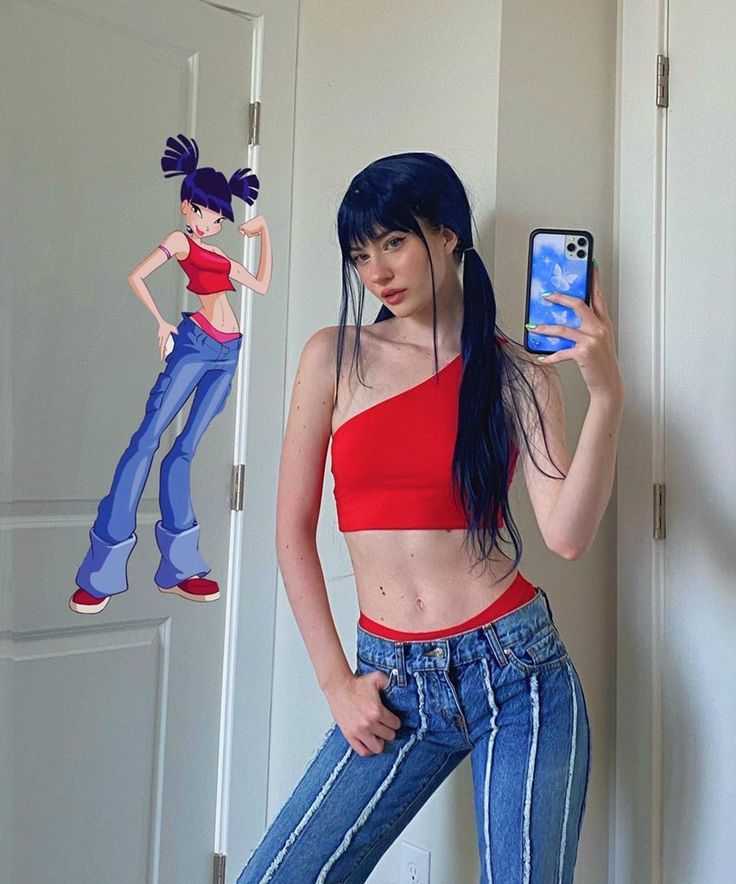 a woman with blue hair is taking a selfie in front of a mirror while holding a cell phone