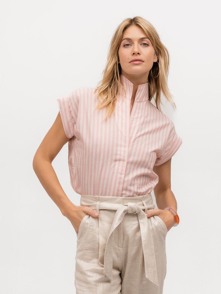 Woman wearing a luxury cap sleeve shirt with pink and cream stripes Summer Daywear Top With Striped Collar, Summer Top With Striped Collar, Pink Short Sleeve Top With Striped Collar, Beige Cotton Top With Striped Collar, Relaxed Fit Tops With Striped Collar For Daywear, Pink Cotton Shirt With Striped Collar, Fitted Pink Linen Top, Fitted Tops With Striped Collar For Spring, Beige Spring Top With Striped Collar