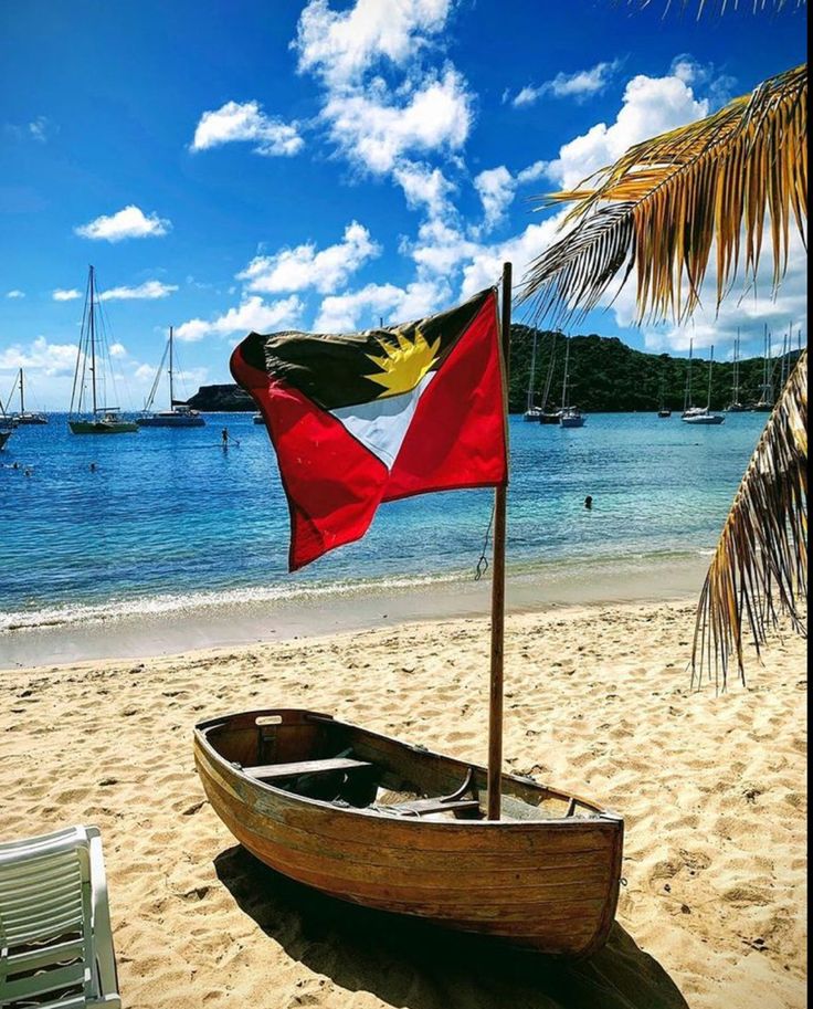 a boat sitting on top of a sandy beach