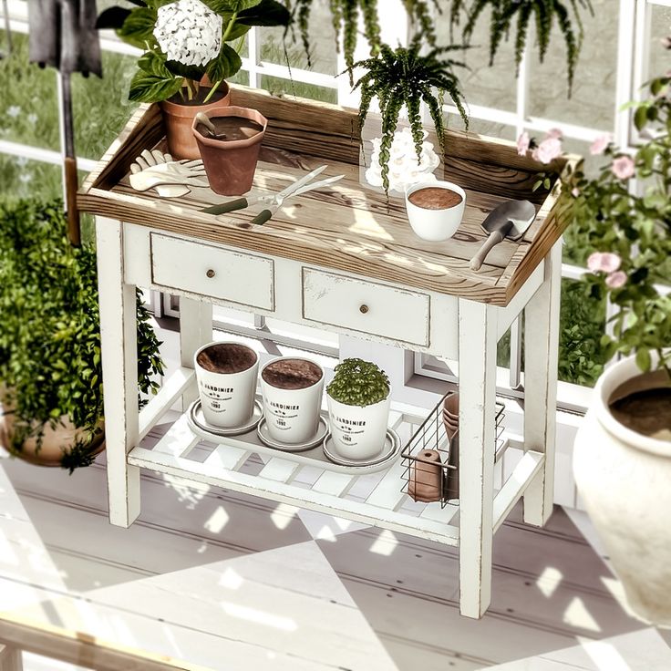 a potted plant sits on top of a small table with pots and plants in it