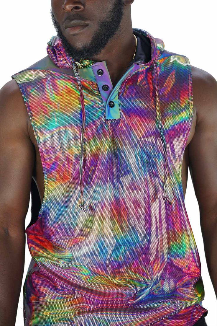 See the world in techno color 😎. The holographic and reflective fabrics in this mens rave tank top will bring your wardrobe to life like you have never experienced before. FEATURES: Hood with drawstring Button down collar Relaxed fit with low arm holes Holographic on the hood and body as well as panels of our signature Photobomber reflective fabric on the back and shoulders Limited edition, once it sells out it's gone forever Ethically made, 100% carbon neutral SIZING: XS - 32 - Chest: 91cm/ 36 Guy Rave Outfits, Rave Outfit Men, Holographic Top, Dubai Festival, Coachella Style, Rave Shirts, Festival Outfits Men, Reflective Fabric, Rave Fits