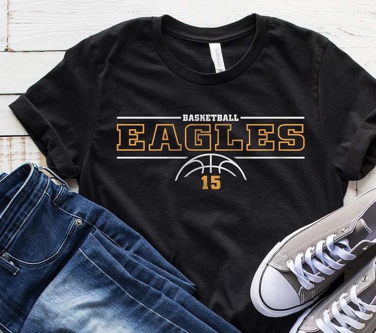 a black shirt with the words basketball pirates on it next to some jeans and sneakers