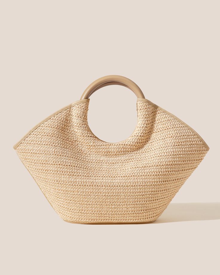 Raffia basket tote with round handle in soft calf leather. Made in Spain by uniquely talented artisans, celebrating excellence in craftsmanship. Chic Natural Beach Bag With Handles, Elegant Natural Straw Tote Bag, Elegant Tote Beach Bag With Braided Handles, Chic Beach Bag With Braided Handles, Elegant Bucket Straw Bag With Leather Handles, Modern Beige Straw Bag With Double Handle, Elegant Straw Bucket Bag With Leather Handles, Elegant Beach Bag With Braided Handles, Chic Double Handle Beach Bag With Bamboo Handle