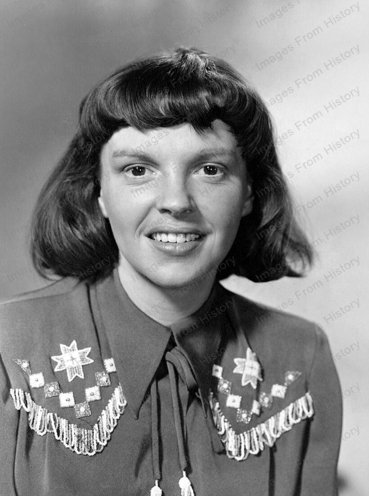 an old black and white photo of a woman in uniform