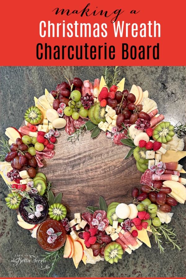 a christmas wreath made out of grapes, apples and other holiday decorations with text overlay reading making a christmas wreath charlotte board