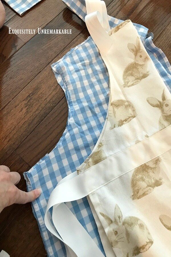 someone is cutting out some fabric to make a bunny dress for their child's easter party