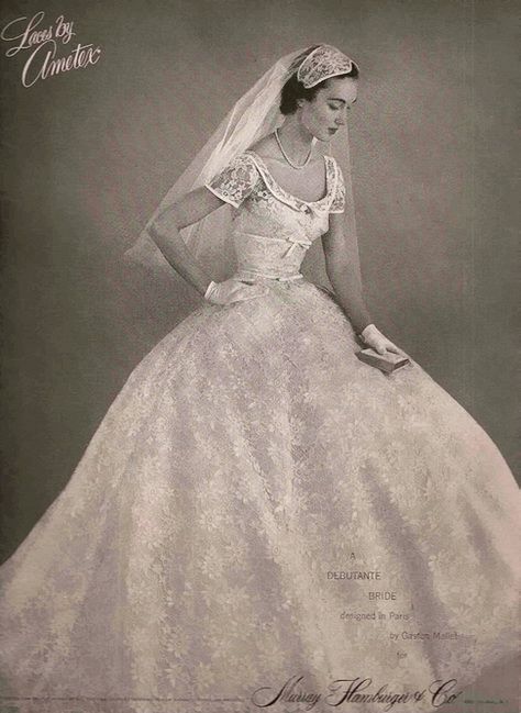 an old fashion photo of a woman in a wedding dress with her hands on her hips