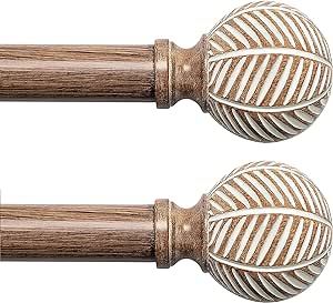 two wooden door knobs with decorative designs on them, one in the shape of a ball