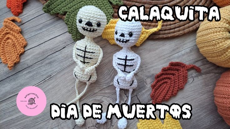 three crocheted skeletons sitting next to each other on top of a wooden floor