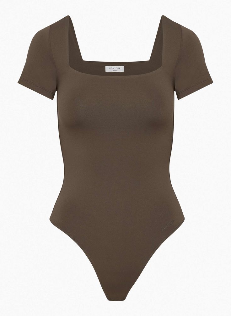 The Contour Contour Squareneck Shortsleeve Bodysuit is a second-skin squareneck shortsleeve bodysuit. A cult classic for a reason. This is a squareneck shortsleeve bodysuit with a thong-cut bottom and double-layer fabric for a supportive fit. It’s made with Aritzia’s Contour — luxe, ultra-flattering fabric coveted for its smoothing effect and second-skin feel. Nothing more essential. Hidden Hold Loops keep your bra straps in place and out of sight. Aritzia Contour, Feel Nothing, Short Bra, Statement Bag, 2024 Christmas, Nothing More, Bra Straps, For A Reason, Shirt Sale