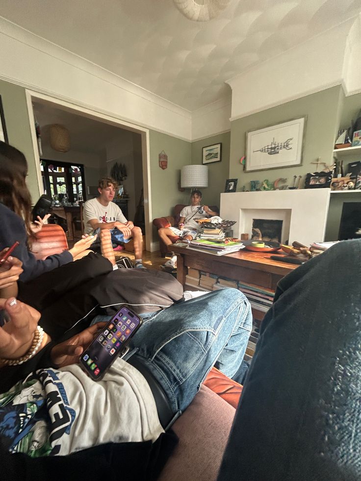 a group of people sitting around in a living room