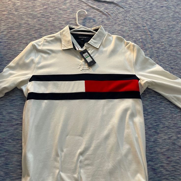 Tommy Hilfiger Long Sleeve Polo Brand New Classic Tommy Hilfiger Tops For Fall, Classic Black Tommy Hilfiger Top, Tommy Hilfiger White Long Sleeve Tops, Tommy Hilfiger Black Long Sleeve Top, Tommy Hilfiger Cotton Polo Shirt, Tommy Hilfiger Long Sleeve Casual T-shirt, Tommy Hilfiger Classic Cotton T-shirt, Tommy Hilfiger Long Sleeve, Tommy Hilfiger Logo Print Cotton T-shirt