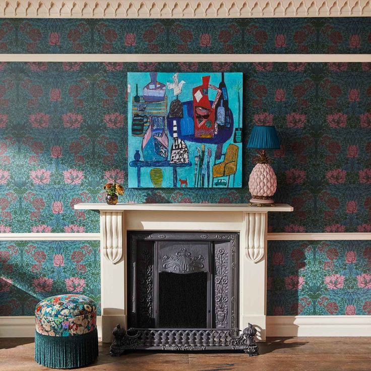 a living room with a fire place and wallpaper on the walls, along with a painting