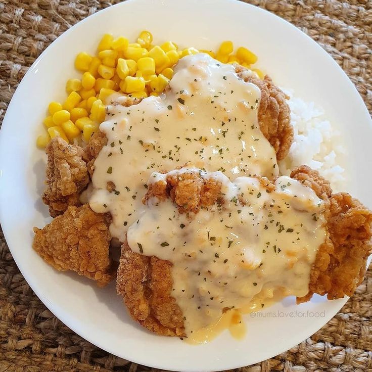 chicken fried with gravy, corn on the cob and mashed potatoes