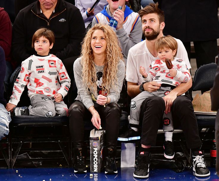 a group of people sitting next to each other at a basketball game