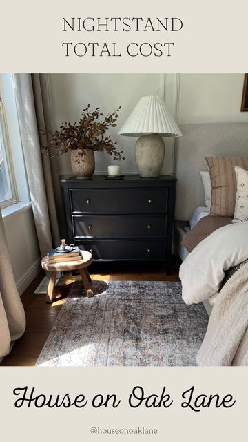 a bed room with a neatly made bed and a night stand next to a window