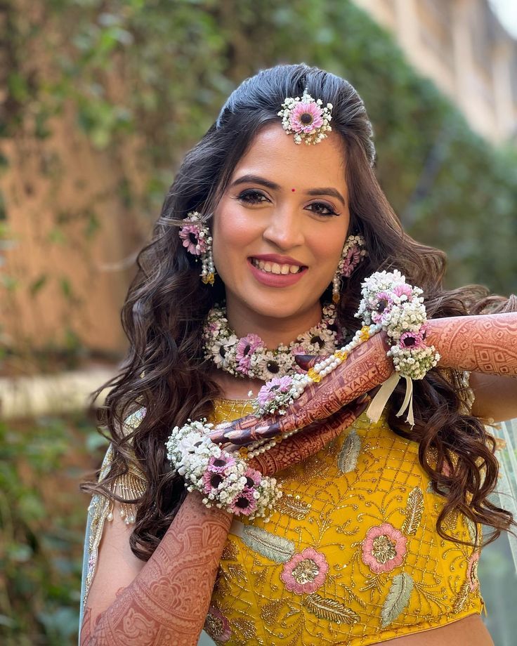 a woman in a yellow dress with flowers on her head and arms around her neck