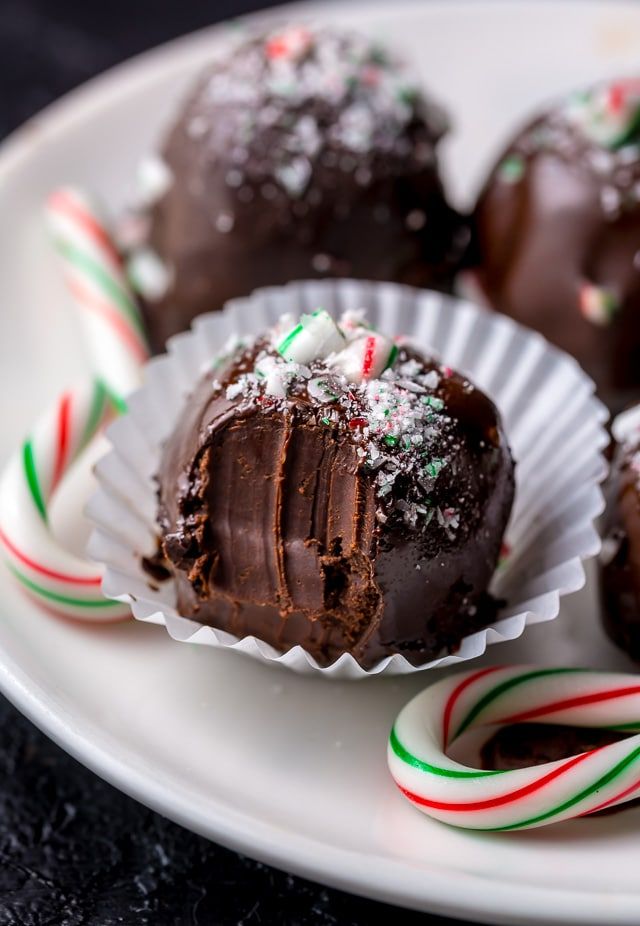 chocolate covered candys and candy canes on a white plate