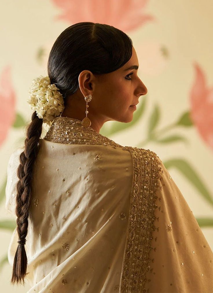 This beautiful ivory and gold Chanderi silk Kurta set exudes grace and elegance, featuring intricate embroidery adorned with sequins, pearls, and cutdana work. The anarkali top has a regal flair with delicate embellishments along the neckline, sleeves, and hemline, adding a luxurious touch to the traditional design. The flowy silhouette is paired with matching straight-cut trousers, offering both comfort and style. Completing the ensemble is a matching ivory dupatta embellished with gold embroidery, which perfectly complements the intricate details of the anarkali. Perfect for pre wedding festivities. Composition: Chanderi Silk Care: Dry Clean Only and Vacuum Storage This product can be customised for sleeves, length of blouse and neckline Delivery : 6-8 weeks as the product is hand crafte Wedding Anarkali Set In Raw Silk With Pearl Embroidery, Pearl Embroidered Anarkali Set For Festivals, Designer Anarkali Set With Pearl Embroidery For Festivals, Designer Pearl Embroidered Anarkali Set For Festivals, Traditional Anarkali Set With Pearl Embroidery For Festivals, Traditional Drape Anarkali Set With Pearl Embroidery For Festivals, Traditional Dupatta With Pearl Embroidery For Reception, Festive Anarkali Set With Pearl Embroidery, Designer Gold Sharara With Pearl Embroidery