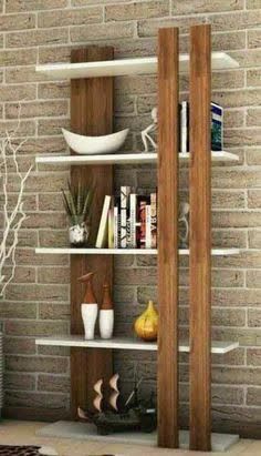 a room with a brick wall and some bookshelves on the shelves in front of it