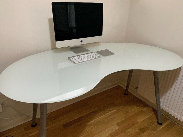 a computer monitor sitting on top of a white desk