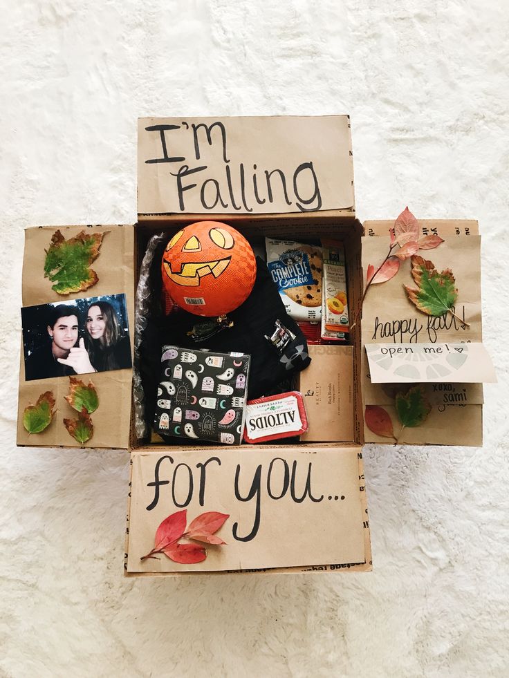 an open cardboard box filled with assorted items and the words i'm falling for you