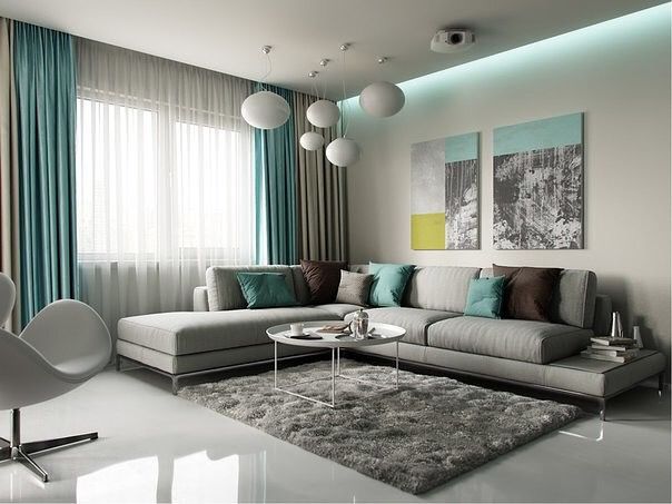 a living room with white furniture and blue curtains