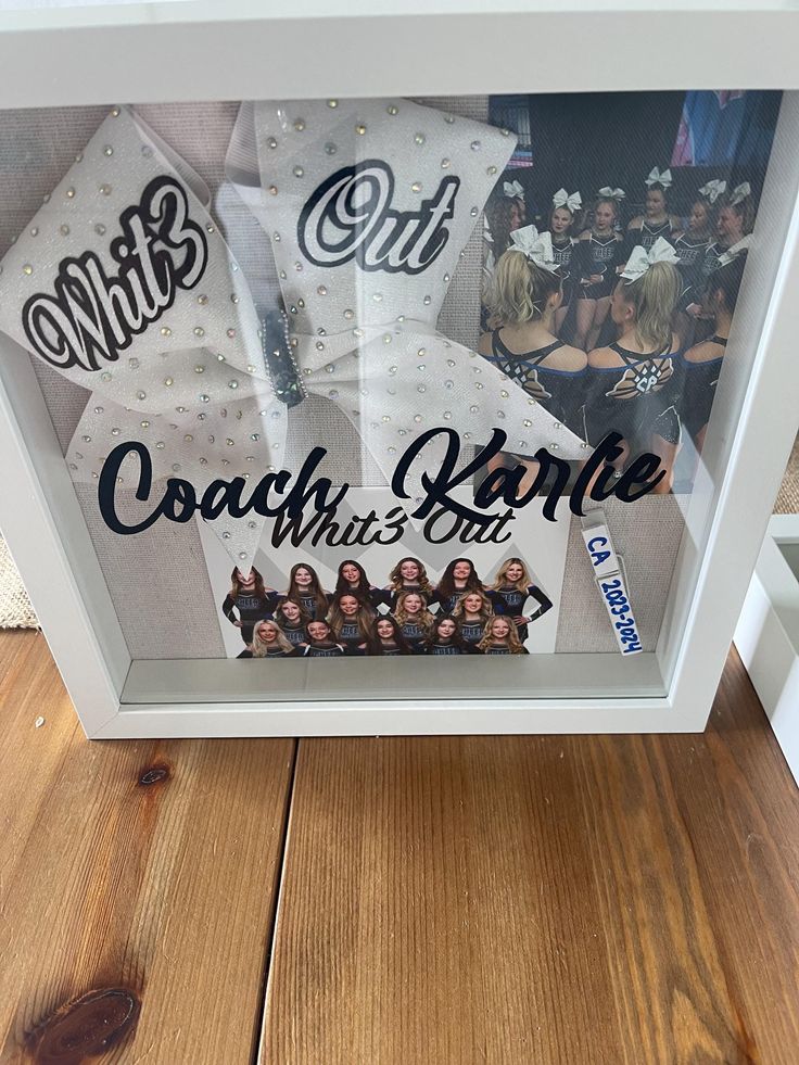 a display case with some pictures in it on a wooden floor next to other items