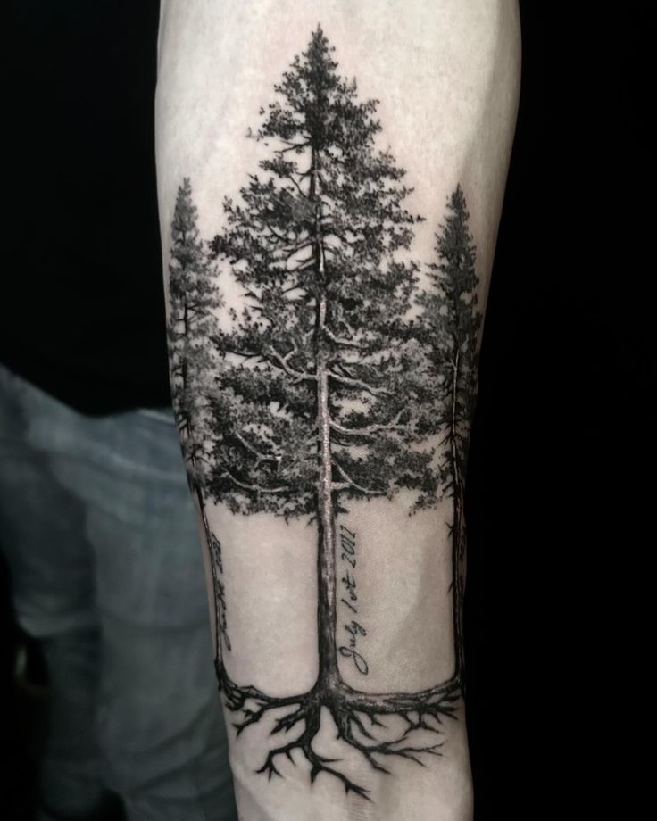 a man's arm with trees and roots on it