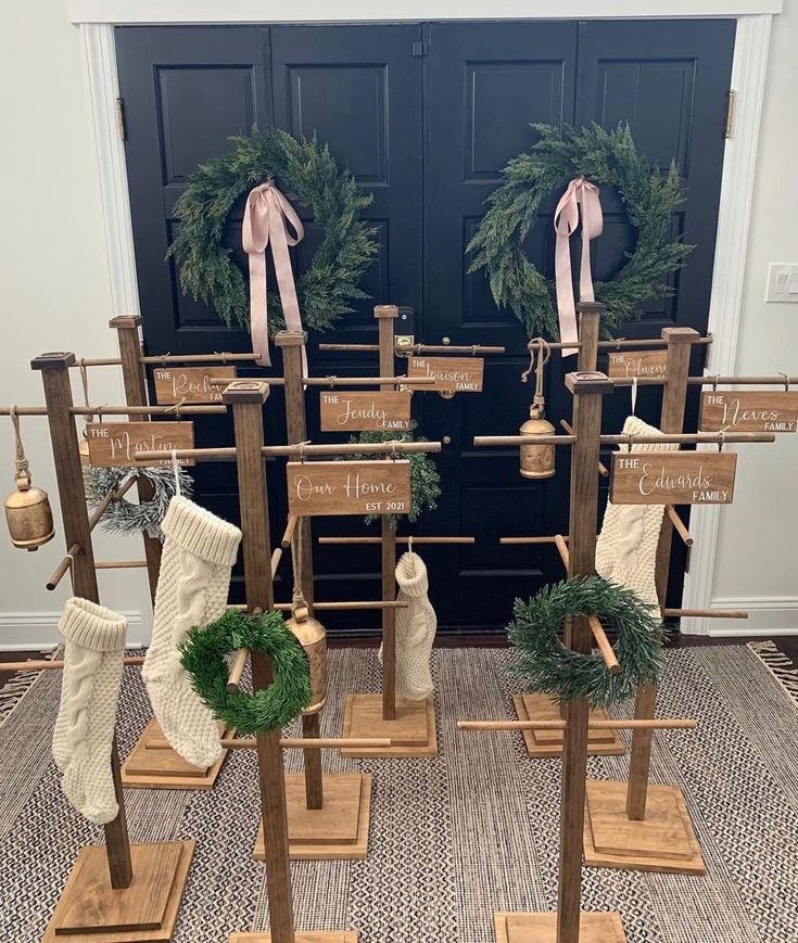 christmas stockings and stocking hangers on display in front of a door with wreaths