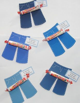 four pieces of blue fabric with labels on them and some candy bar in the middle