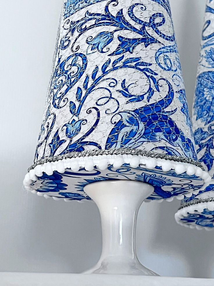 two blue and white lamps on a table