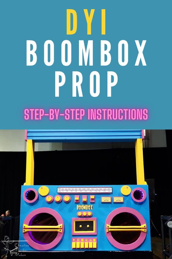 the boombox prop is on display in front of a blue backdrop with pink and yellow trim