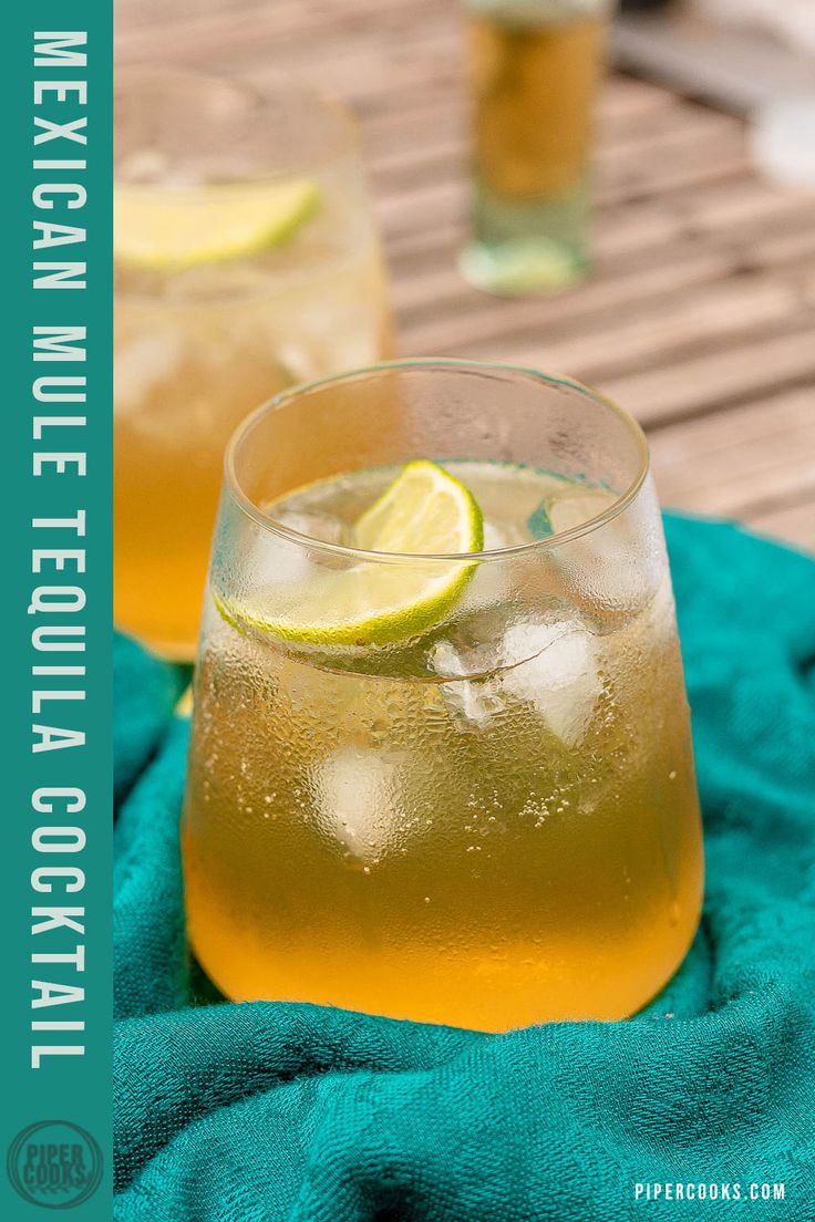 two glasses filled with lemonade on top of a blue towel next to a wooden table