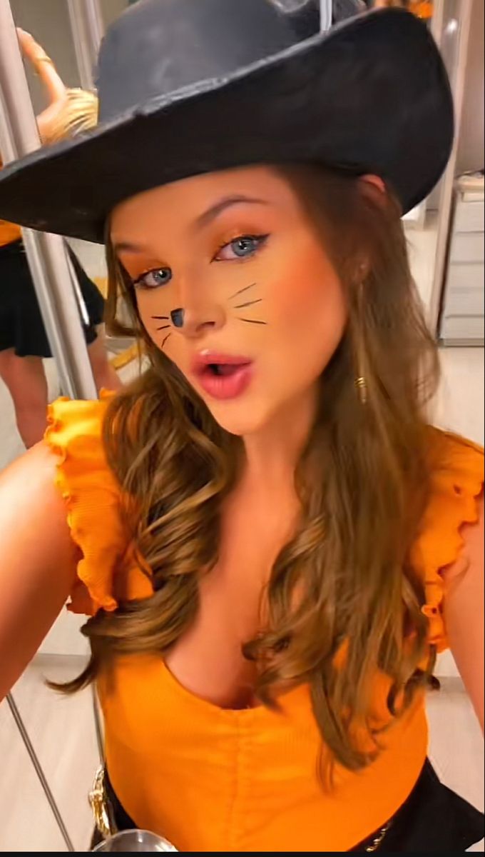 a woman wearing a cat costume and hat