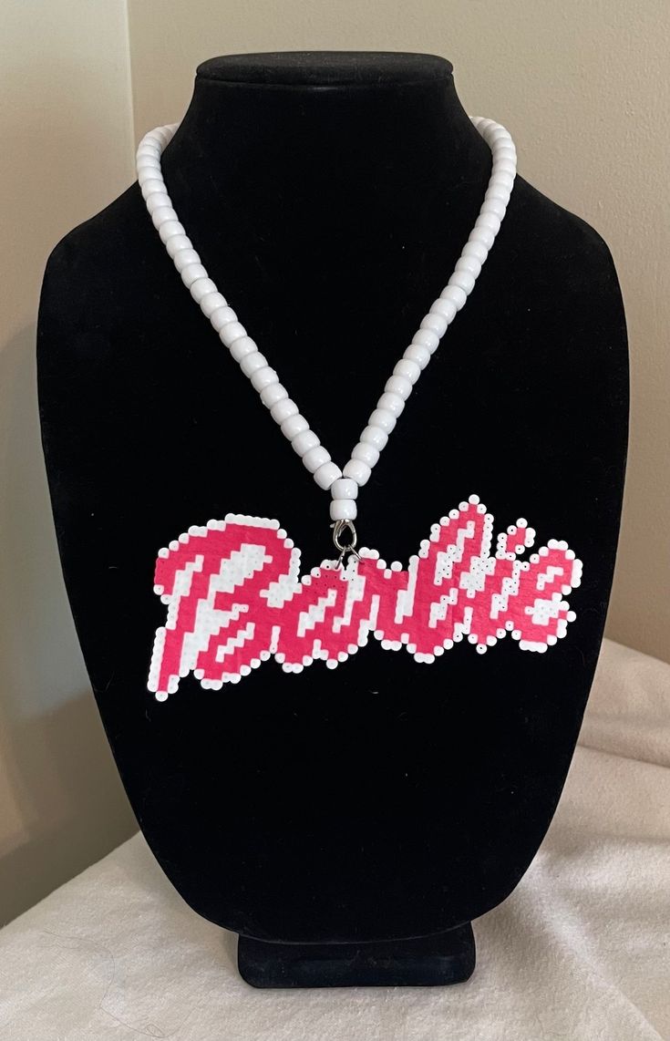 a beaded necklace with the word barbie on it