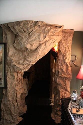 a room that has some kind of cave on the wall and lights in the doorway