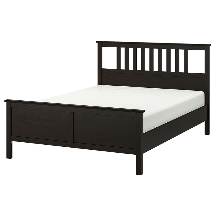 a black bed frame with two drawers on each side and a white sheet under it