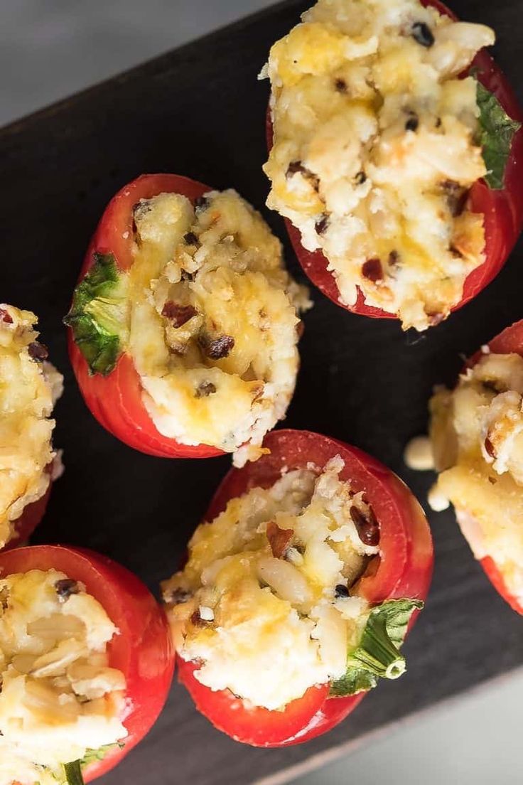 several stuffed red peppers with cheese and herbs