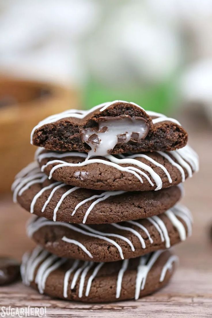 a stack of chocolate cookies with white icing