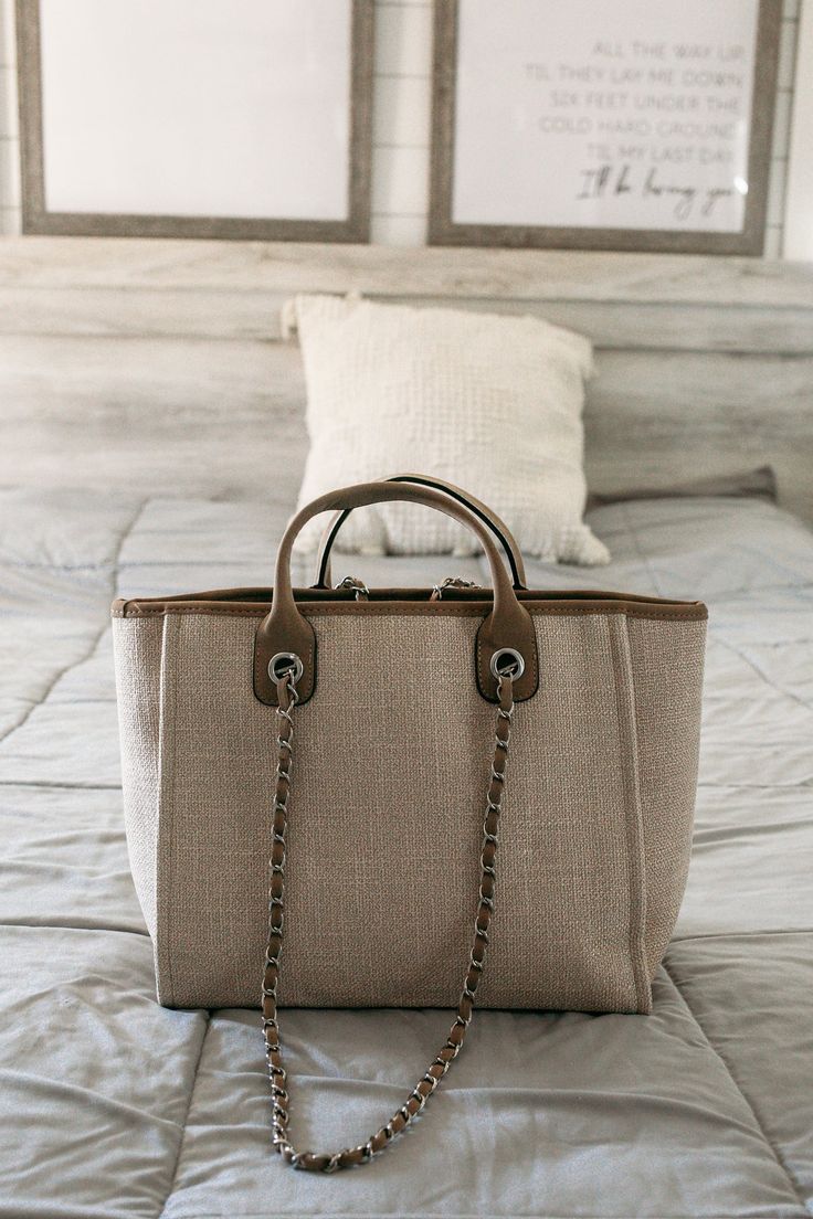 A gorgeous new designer-inspired tote! This bag is the perfect neutral and looks as expensive as it feels but it's a steal! Material is canvas, faux leather, and nylon liner. Inside features two slide in pockets, one zip pocket, and zipper closure. Chain handles are approx. 13.5 in. Bag itself is approx. 16in x 11 in x 6.5 inch in size. ALL SALES FINAL. Elegant Tote Canvas Bag For On-the-go, Chic Coated Canvas Bag For On-the-go, Chic Canvas Bag For On-the-go, Beige Bag With Canvas Lining For On-the-go, Chic Rectangular Canvas Bag With Zipper Closure, Chic Canvas Tote Bag With Zipper Closure, Trendy Bag With Canvas Lining And Double Handle, Chic Canvas Bag With Zipper And Double Handle, Chic Double Handle Canvas Bag With Zipper