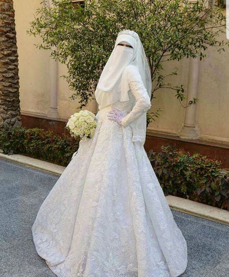 a woman in a white wedding dress and veil