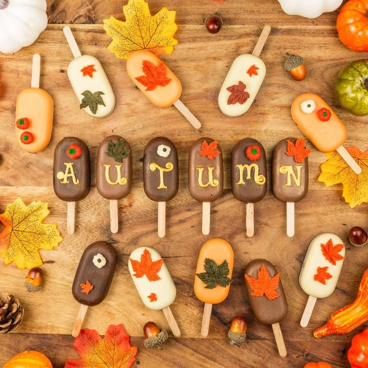 autumn candy pops are arranged on a wooden table